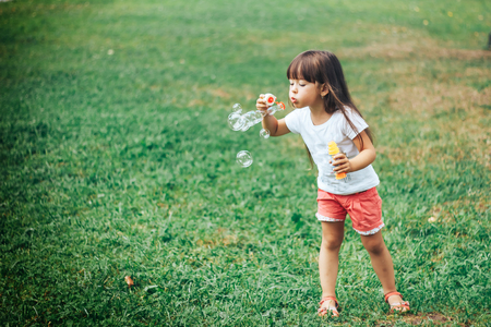 girl blowing soap bubblesの写真素材