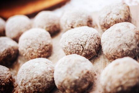 Wooden background. Uncooked turkey burgers on wooden board. Preparing dinner.の写真素材