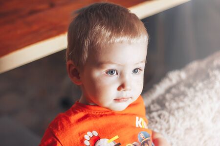 baby boy looking at somethingの写真素材