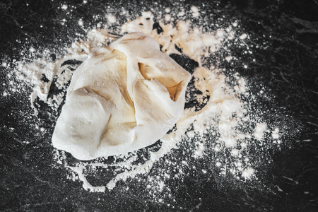 dough with close-up. woman is preparing bread dough. not round ball. copyspaceの写真素材