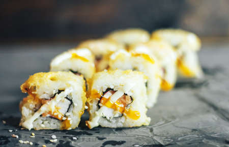 Salmon Fried Maki Sushi - Hot Roll with Cream Cheese and Cucumber inside. Deep Fried Salmon outside.の写真素材