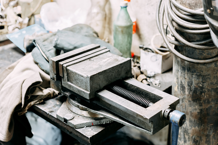 Vise tool in workshop or the garage for support hard work, Special tools for industry job, vise stand on the table with other basic tooの写真素材