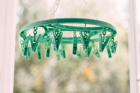 Colored clothespins on a rope on a blurred background