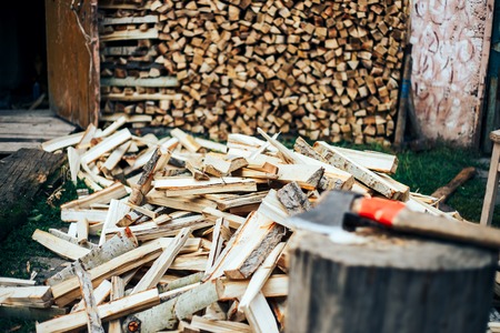 Firewood in woodpile under the sunshine Woodpiles background. Stacked firewood background, light brown firewood texture outdoors.の写真素材
