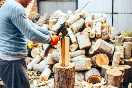 Detail of two flying pieces of wood on log with sawdust. Man is chopping wood with vintage axe. Frozen moment.の写真素材