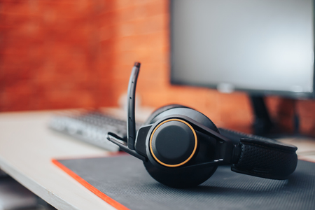 gaming Headphone with microphone and monitor on table background at home gamer conceps selected focusの写真素材