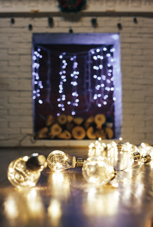 christmas garland blurred lights background with golden and violet colors fireplace background selected focusの写真素材