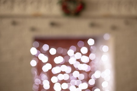 Christmas decorations on the base, unfocused in the background is a fireplace with a soldier and socks for Santa Claus.の写真素材