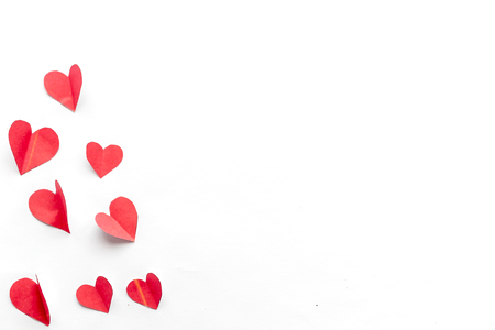 Flying red paper hearts on white background. Valentine's Day. Symbol of love. Copy space. Copy space. close up minimalism top viewの写真素材