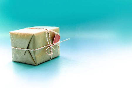 Gift boxe wrapped in kraft paper tied with candy cane Christmas rope on dark blue background. New Year concept, top view, minimal styled.の写真素材