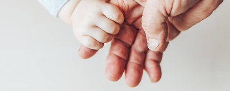 An old woman and a kid holding hands together selected focus on table long banner