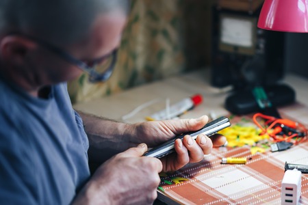 man hands repair make broken tv remote.