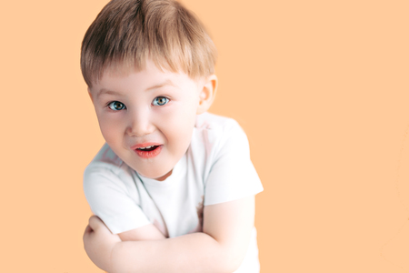 Portrait of little boy screaming with opened mouth and crazy expression. Surprised or shocked face.の写真素材