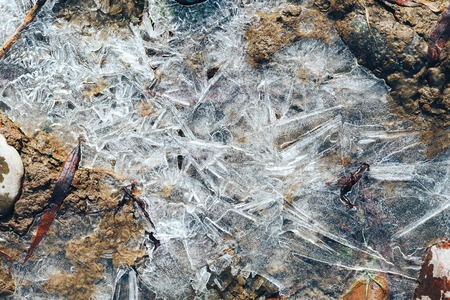 ice crystals pattern over frozen puddle on spring river.の写真素材