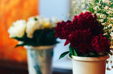 beautiful pions in vases standing on table, gift for woman.の写真素材