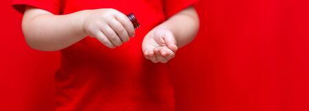 little child boy pours pills from the can into the hand,healthy concept. It is dangerous tablets in...