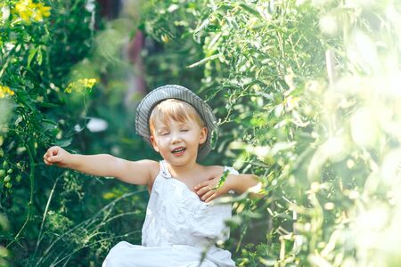 casual chilling out on grass, farmer boy three years old.の写真素材