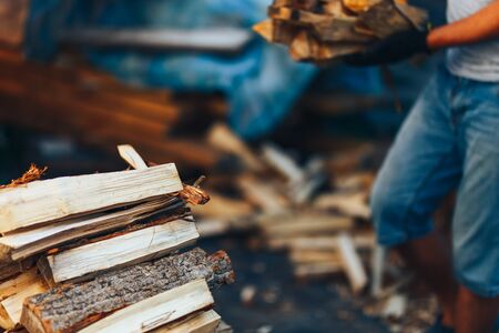 A pile of stacked firewood, prepared for heating the house. Gathering fire wood for winter or...