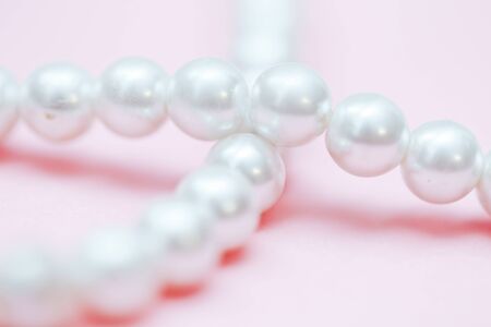 string of pearls delicate pink color, in soft focus, with highlights.の写真素材