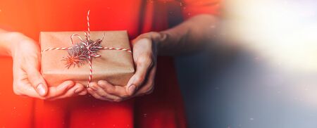 Woman holding christmas gift.の写真素材