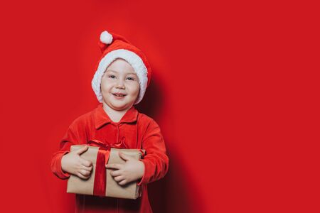 little boy holding christmas giftの写真素材