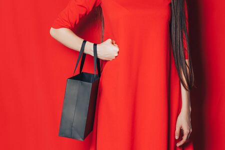 woman in red dress black bagの写真素材