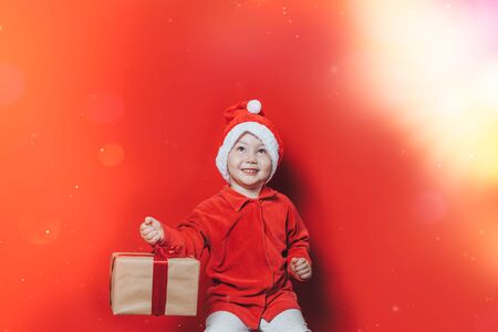 little boy holding christmas giftの写真素材