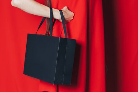 woman in red dress black bagの写真素材