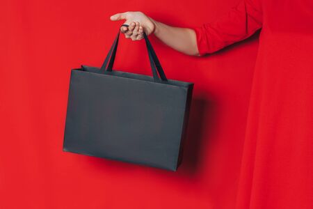 woman in red dress black bagの写真素材