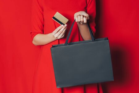 woman hands with black package and credit cardの写真素材