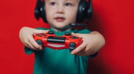 Small boy playing video gameの写真素材