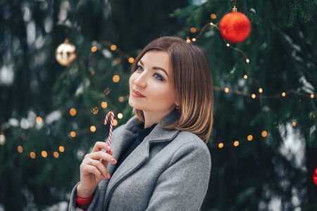 Woman near christmas tree outdoorの写真素材