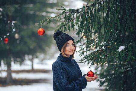 Woman near christmas tree outdoorの写真素材