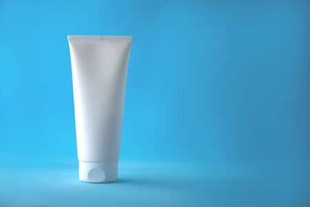 Blank white tube on blue backgroundの写真素材
