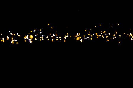 glitter lights on black backgroundの写真素材