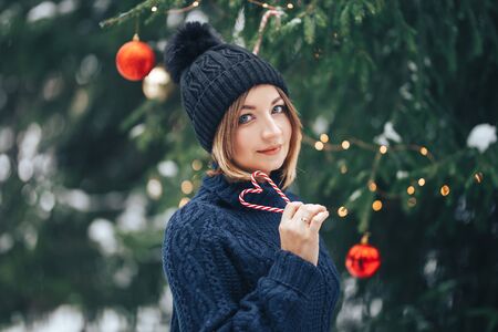 Woman near christmas tree outdoorの写真素材