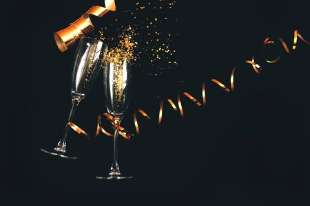 Two champagne glasses with golden glitterの写真素材