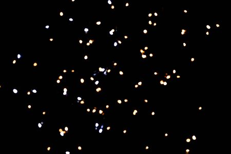 glitter lights on black backgroundの写真素材