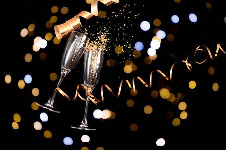 Two champagne glasses with golden glitterの写真素材