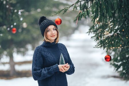 Woman near christmas tree outdoorの写真素材