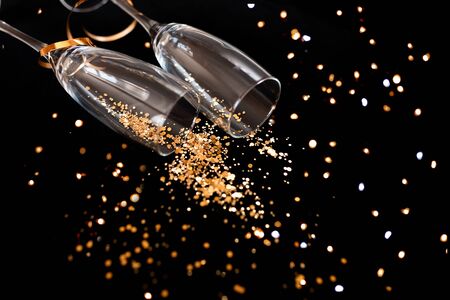 Two champagne glasses with golden glitterの写真素材