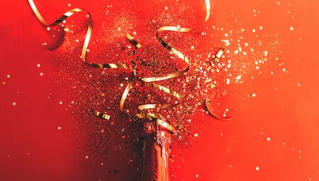 bottle of champagne near confettiの写真素材
