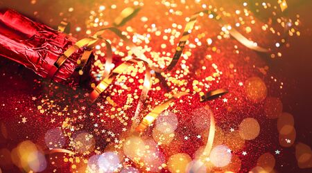 bottle of champagne near confettiの写真素材