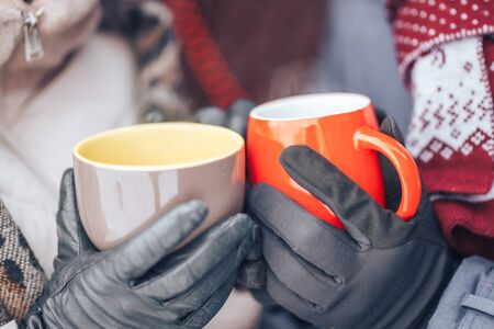 Hands of couple with hot cups.の写真素材
