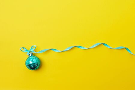 One christmas ball on yellow backgroundの写真素材