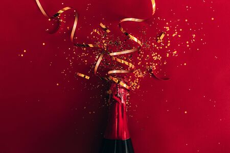 bottle of champagne near confettiの写真素材