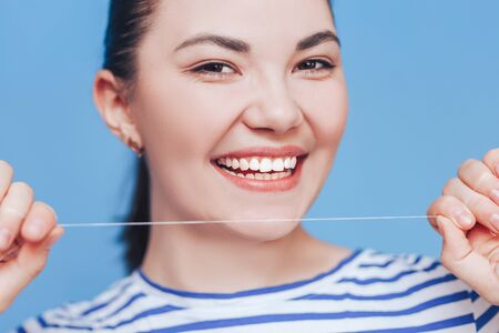 Woman smile with dental flossの写真素材
