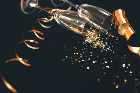 Two champagne glasses with golden glitterの写真素材