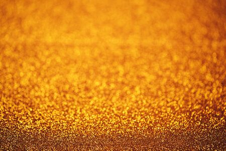 Christmas abstract texture, golden sparkles bokeh shining background.の写真素材