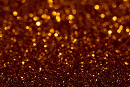 Christmas abstract texture, golden sparkles bokeh shining background.の写真素材